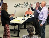  Shellie Scobee, left, swears in new board members Mike Calahan and Jon Waller
